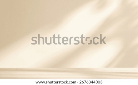 Sunlight and shadows gently fall on a beige wall and floor, creating a soft and warm backdrop with subtle textures, tonal variations, and a calm, serene visual effect.
