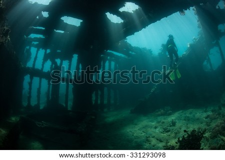 Sunlight shines down into the interior of a world war II shipwreck off the coast of Guadalcanal in the Solomon Islands. Shipwrecks act as artificial reefs, attracting many fish and invertebrates.