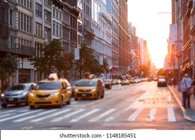 Sunlight Shines Down The Streets Of New York City With Taxis Stopped At The Intersection 