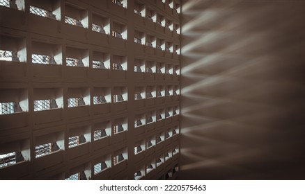 The Sunlight Shines Through Light Channels Wall Of Old Gymnasium. Concrete Walls Have Holes For Sunlight To Penetrate Through The Holes From The Outside, Light And Shadow Concept, Selective Focus.