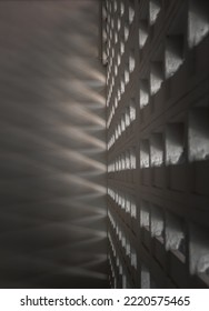 The Sunlight Shines Through Light Channels Wall Of Old Gymnasium. Concrete Walls Have Holes For Sunlight To Penetrate Through The Holes From The Outside, Light And Shadow Concept, Selective Focus.