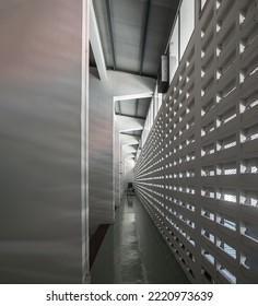 The Sunlight Shines Through Light Channels Wall Of Old Gymnasium. Concrete Walls Have Holes For Sunlight To Penetrate Through The Holes From The Outside, Light And Shadow Concept, Selective Focus.