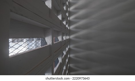 The Sunlight Shines Through Light Channels Wall Of Old Gymnasium. Concrete Walls Have Holes For Sunlight To Penetrate Through The Holes From The Outside, Light And Shadow Concept, Selective Focus.