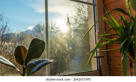 Sunlight shines in through the window of a beautiful. Silhouette of church and cloudy sky on background. - Powered by Shutterstock