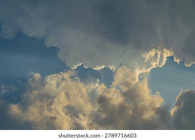 Sunlight streams through dramatic clouds, creating a sense of awe and wonder.