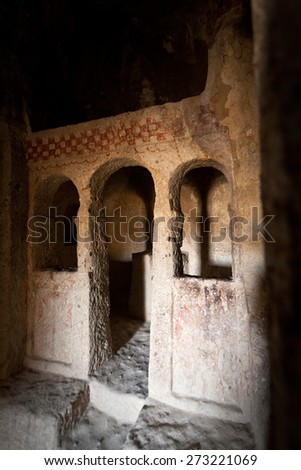 Sunlight through cave opening falling on dark church at Cappadocia Turkey