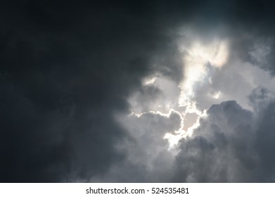 Sunlight Through Very Dark Clouds Background