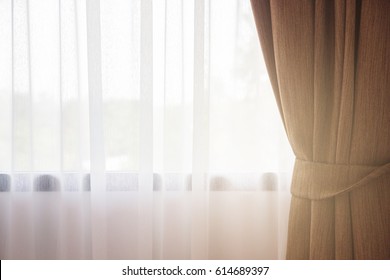 Sunlight through the white curtain and windows