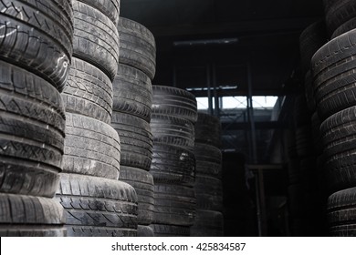 Sunlight In The Tire Storage. Stack Of Old Tires In A Car Shop Garage. Tire Installation Service.