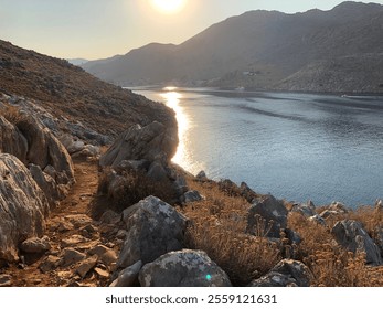 Sunlit coastal landscape with rocky hiking trail. - Powered by Shutterstock