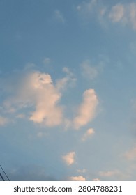 Sunlit Evening Clouds Against a Blue Sky