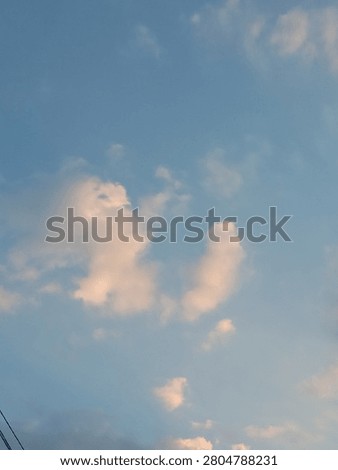 Sunlit Evening Clouds Against a Blue Sky