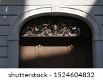 sunlit gate of a house with an elegant openwork lunet of wrought iron, in Sankt Gallen, Switzerland