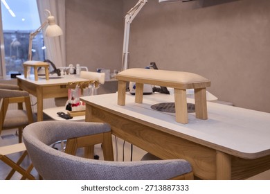sunlit manicure studio with empty workstations, wooden tables, cushioned stools, adjustable LED lamps, neatly organized nail polish rack, soft beige palette,