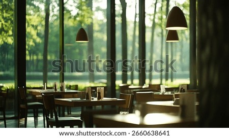 Sunlit restaurant interior with large windows overlooking a lush green park. Tables and chairs are arranged for dining
