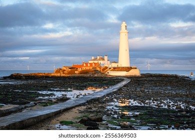 Sunlit St Mary's Lighthouse at low tide, on the small rocky St Mary's Island, just north of Whitley Bay on the North East coast of England - Powered by Shutterstock