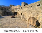 Sunlit walls of medieval fortress in Mediterranean sea area