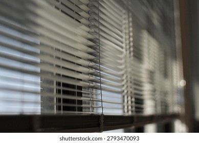 Sunlit Window Blinds Casting Soft Shadows Across Interior Office Window Sill And Glass
