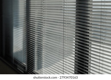 Sunlit Window Blinds Casting Soft Shadows Across Interior Office Window Sill And Glass