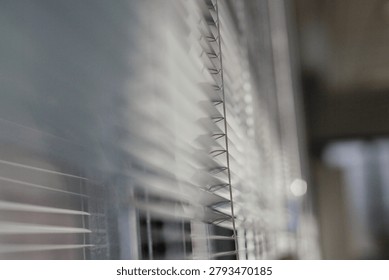 Sunlit Window Blinds Casting Soft Shadows Across Interior Office Window Sill And Glass