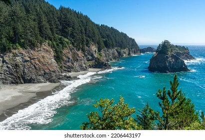A sunny afternoon image of the beach and rocky cliffs that are south of the Arch Rock in the southern part of the Oregon Coast. - Shutterstock ID 2206443197