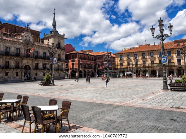 A sunny afternoon at Plaza\
Mayor in Leon, Spain. Tables and chairs arranged for al fresco\
dining.