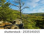 Sunny Autumn landscape featuring the high altitude view from a rocky cliff at Devil’s Lake State Park near Baraboo, Wisconsin.