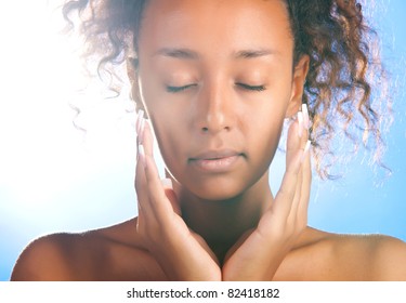 Sunny Beautiful Woman With Is Touching Her Face And Looking At Camera On Sky Background