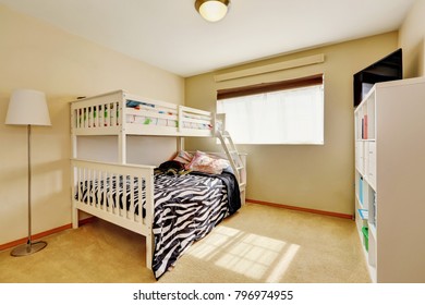 Sunny Beige Kids' Room With A Bunk Bed With Built-in Ladder And Dressed In Zebra Print Bedding. Northwest, USA