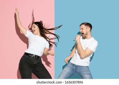 Sunny. Dancing, singing, having fun. Young and happy man and woman in casual clothes on pink, blue bicolored background. Concept of human emotions, facial expession, relations, ad. Beautiful couple. - Shutterstock ID 1636307896