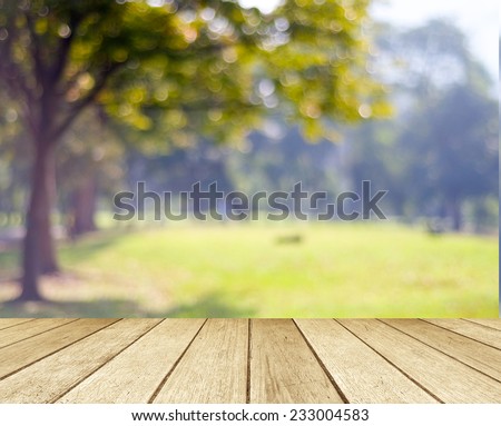 Sunny day background, Blur park, outside  landscape with bokeh light, Wood table and blur tree garden nature in sunny day background, Picnic table top for food and product display backdrop, mockup
