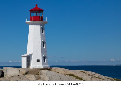 Sunny day at the iconic Peggy's Point Lighthouse, at the entrance to St. Margaret's Bay, on the  rocky shore of Peggy's Cove, Nova Scotia Canada - Powered by Shutterstock