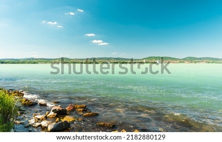 Sunny day at lake Balaton. Viewing the shore and hills of Balatonfüred. 商業照片 © 