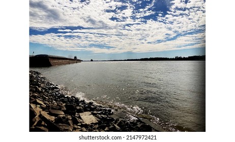 A Sunny Day At The Mississippi River Right Outside Baton Rouge! Very Amazing Sky And Water With A Few Barges In Sight.