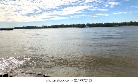 A Sunny Day At The Mississippi River Right Outside Baton Rouge! Very Amazing Sky And Water With A Few Barges In Sight.