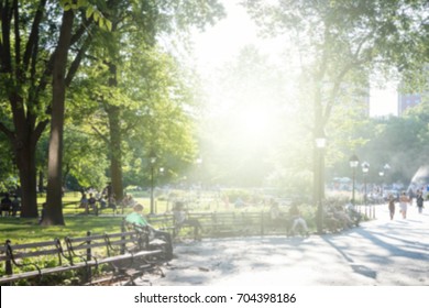 Sunny Day In New York City Park Blurred Background Scene With Sunlight Shining On Crowds Of People