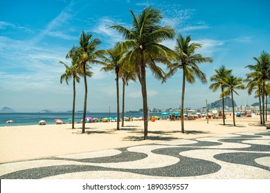 Sunny day on famous Copacabana Beach with palm trees and blue sky in Rio de Janeiro, Brazil