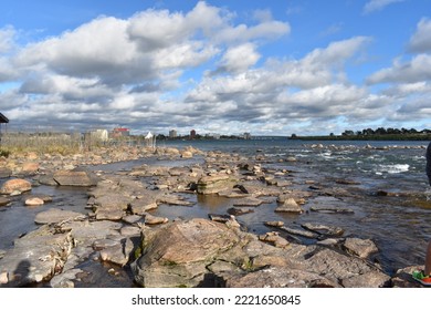 A sunny day in sault Saint Marie, Ontario. A view facing the United States of America from the Canadian side. Big luscious clouds fill the blue sky. - Shutterstock ID 2221650845