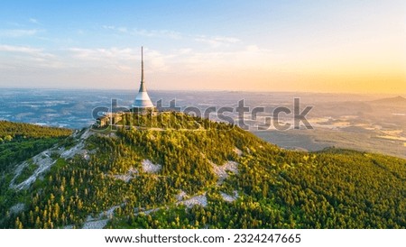 Sunny evening at Jested Mountain with unique building on the summit. Liberec, Czech Republic. Aerial view from drone.