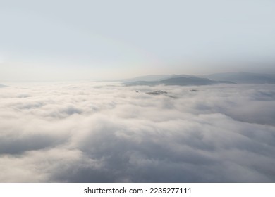 sunny foggy clouds in winter with small mountain view in winter season for create nature content. drone high view for content editing.