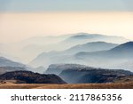 Sunny foothills and hills and Padana plain or Po valley with fog, seen from Lessinia plateau (Altopiano della Lessinia), on horizon the mountain range of the Apennines. Erbezzo, Verona, Veneto, Italy.