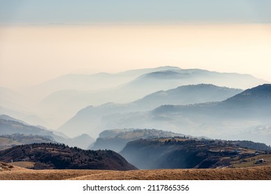 Sunny foothills and hills and Padana plain or Po valley with fog, seen from Lessinia plateau (Altopiano della Lessinia), on horizon the mountain range of the Apennines. Erbezzo, Verona, Veneto, Italy. - Shutterstock ID 2117865356