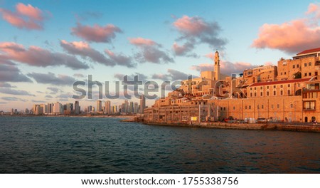Sunny Jaffa Old City and Tel Aviv skyline at sunset. Ancient sea port