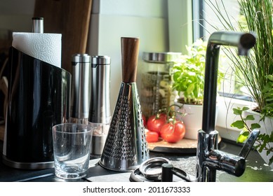 Sunny Kitchen Window With Various Kitchen Utensils And Vegetables On The Windowsill