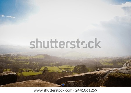 Sunny landscape with rolling hills and clear skies, ideal for travel and nature themes at Brimham Rocks, in North Yorkshire