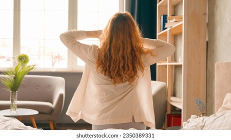 Sunny morning at home bedroom girl wake up at hotel woman waking up after tranquil sleeping healthy sleep stretching in cozy bed female enjoy soft orthopedic mattress awake go away walking start day - Powered by Shutterstock