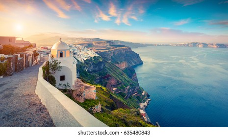 Sunny morning panorama of Santorini island. Picturesque spring sunrise on the famous Greek resort Thira, Greece, Europe. Traveling concept background. Artistic style post processed photo.