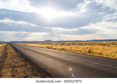 Sunny Open Road On A Cloudy Day In The Middle Of Nowhere 