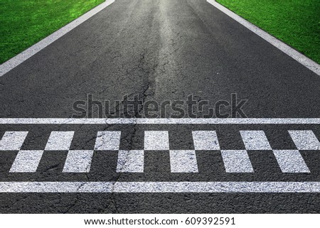 Sunny race road details with finish and start line pattern background.