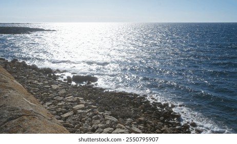 Sunny rocky coastline with sparkling blue sea in gallipoli, puglia, salento, italy, showcasing scenic views and clear waters near the shore. - Powered by Shutterstock